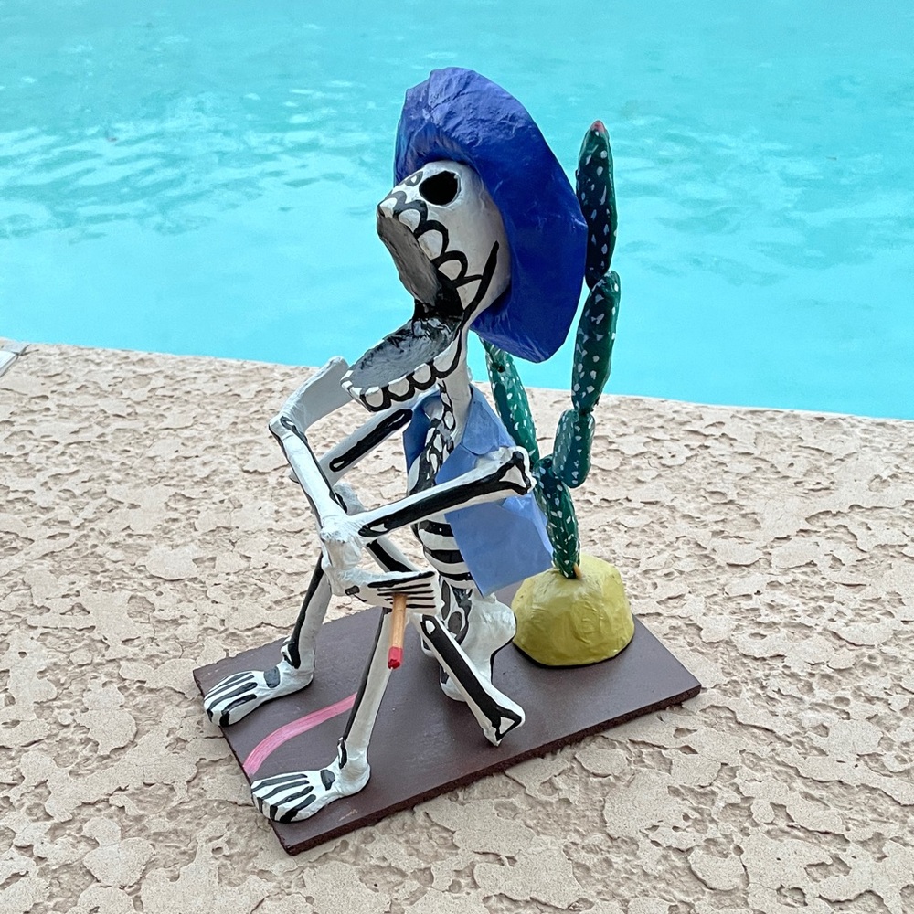 Mexican Folk Art Skeleton with Hat, Cigarette on its hand & Cactus Accent